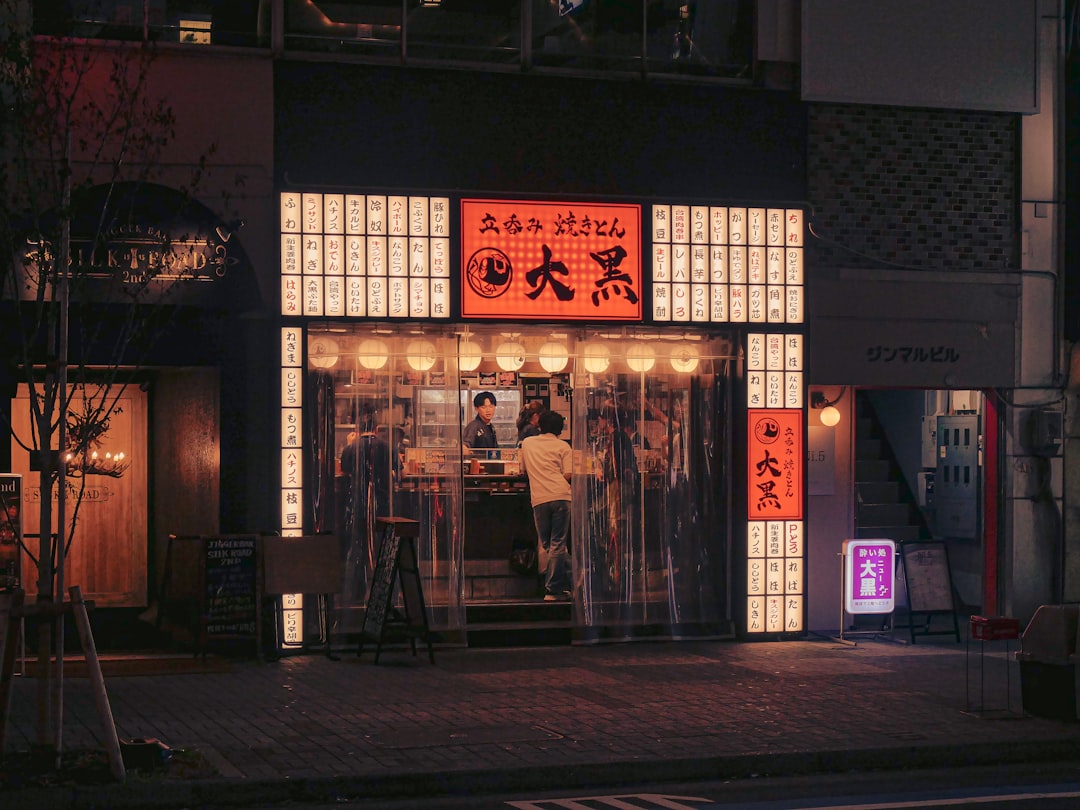 Restaurant entrance at night with illuminated signage