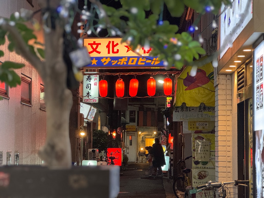 A city street at night with a chinese restaurant in the background