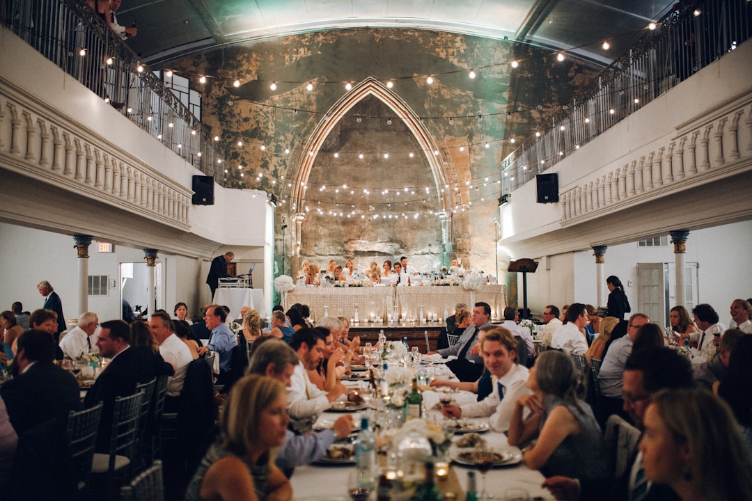 Wedding reception dinner with guests seated at tables.