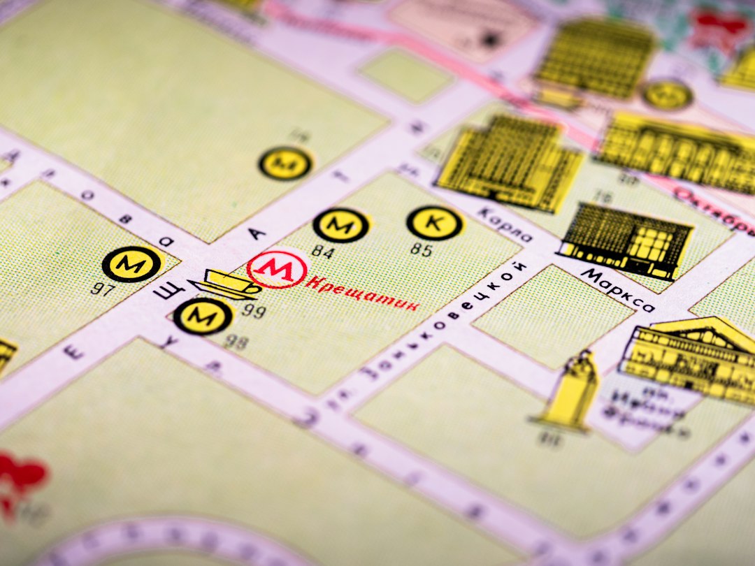 A close-up of a printed city map with metro station symbols and street names